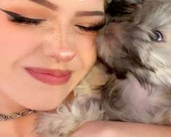 She has also adopted a cute dog and cuddles him to show her love to him She has also adopted a cute dog and cuddles him to show her love to him.
